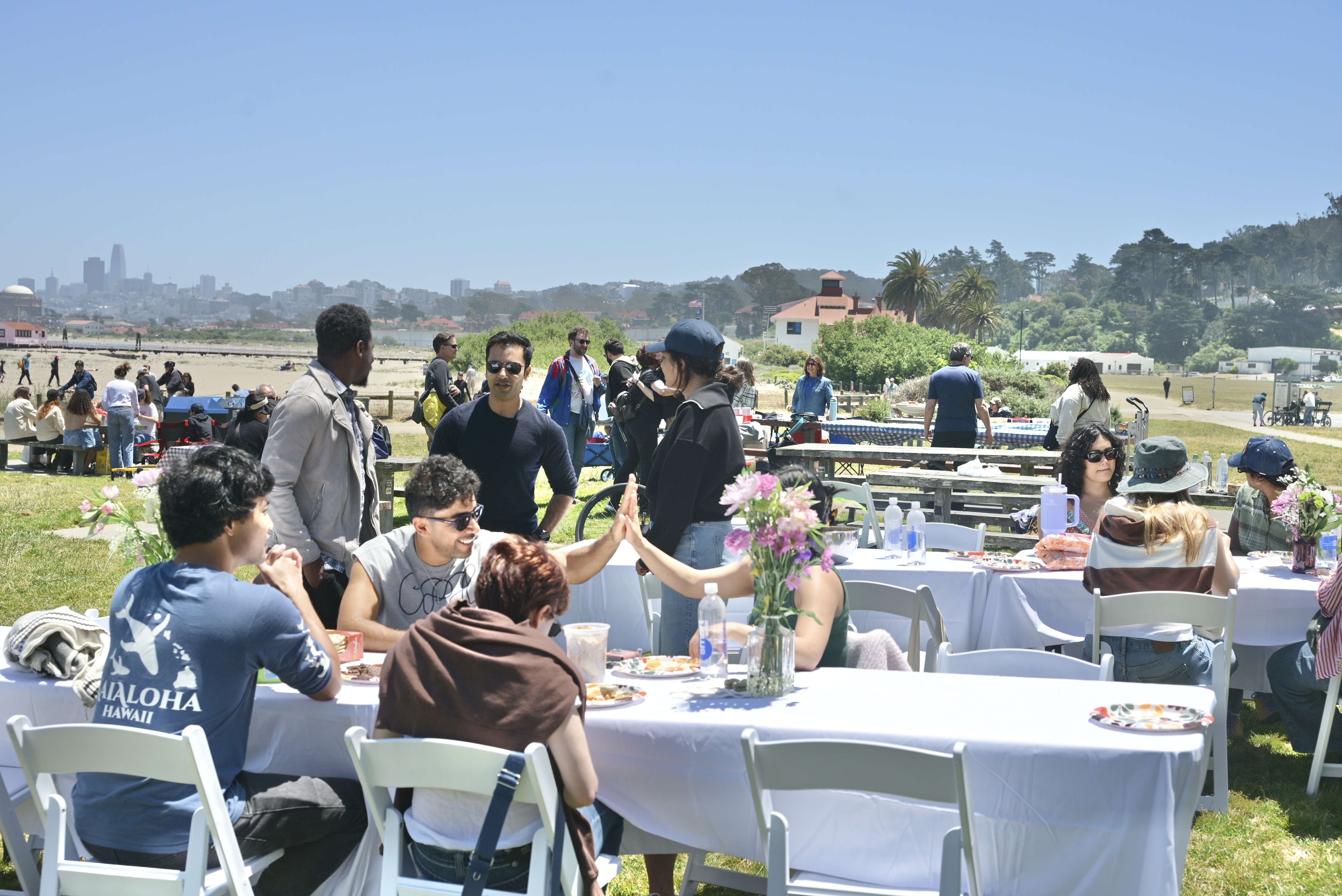Friends sharing a meal at a Table Talk event with a city and bridge view